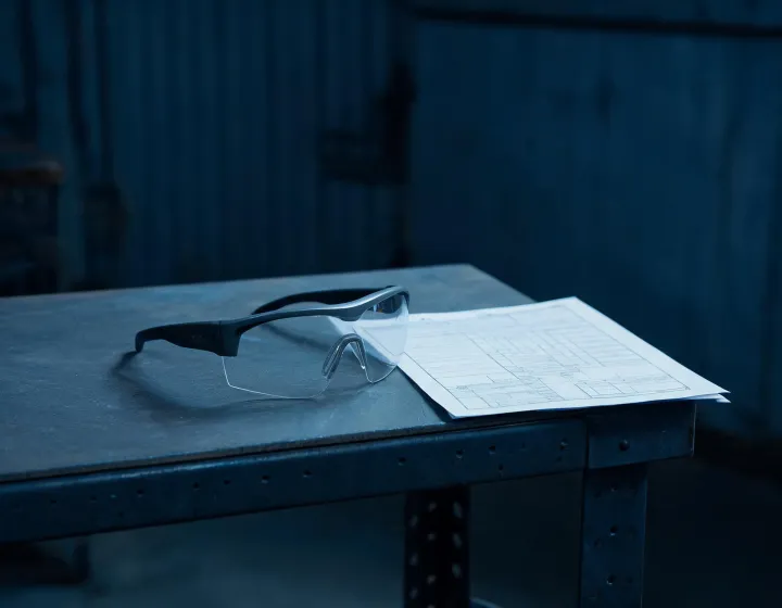 Unlabeled custom z87 safety glasses on a PPE intake bench